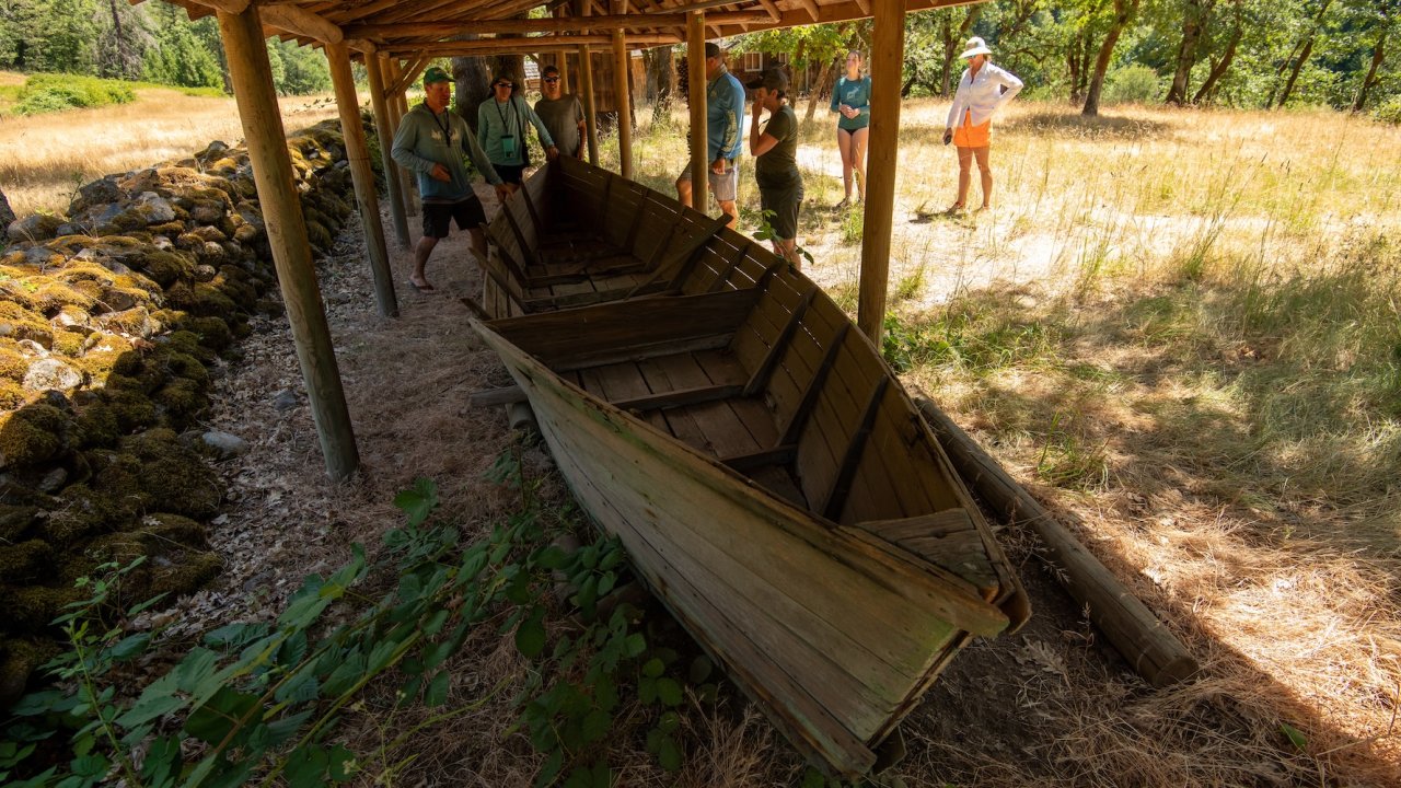 People walking around a historic site along the Rogue River in Oregon