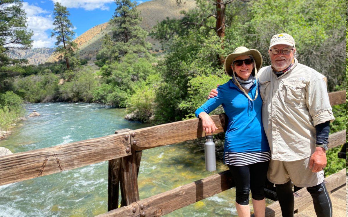 A couple posing on a bridge while on a ROW Adventures rafting trip