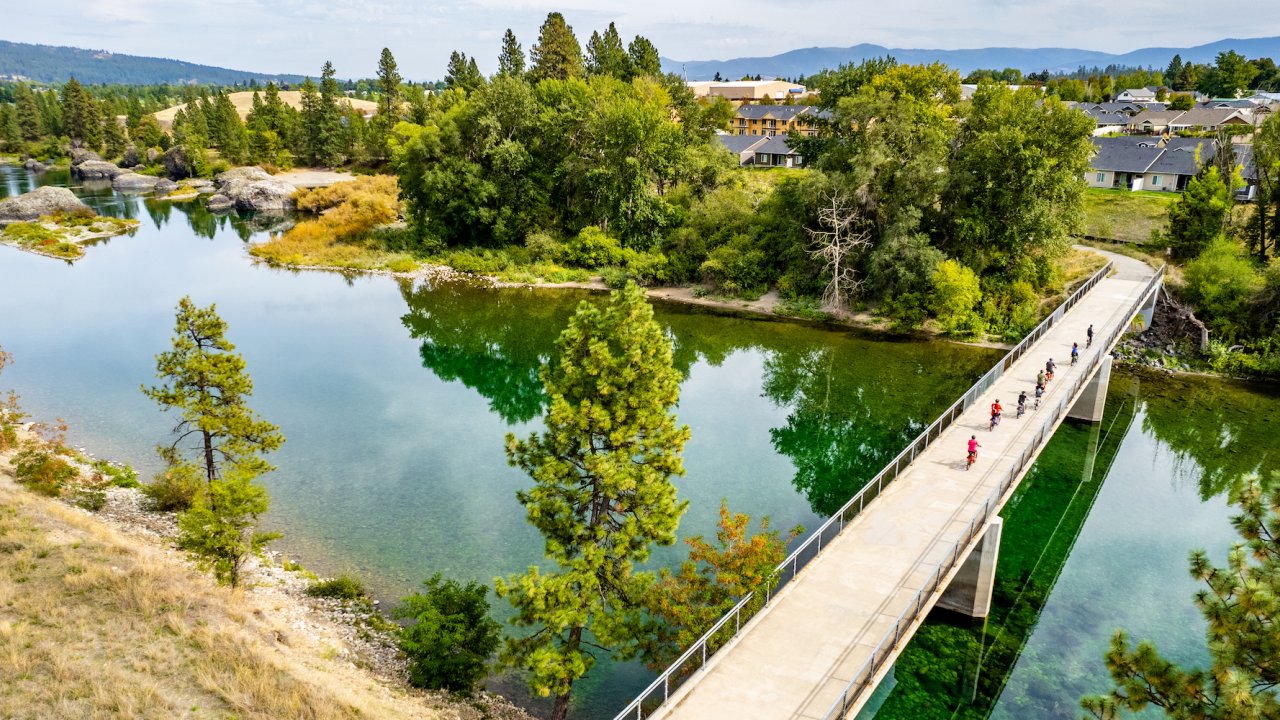 Arial shot of bikers pedaling across a bridge in North Idaho