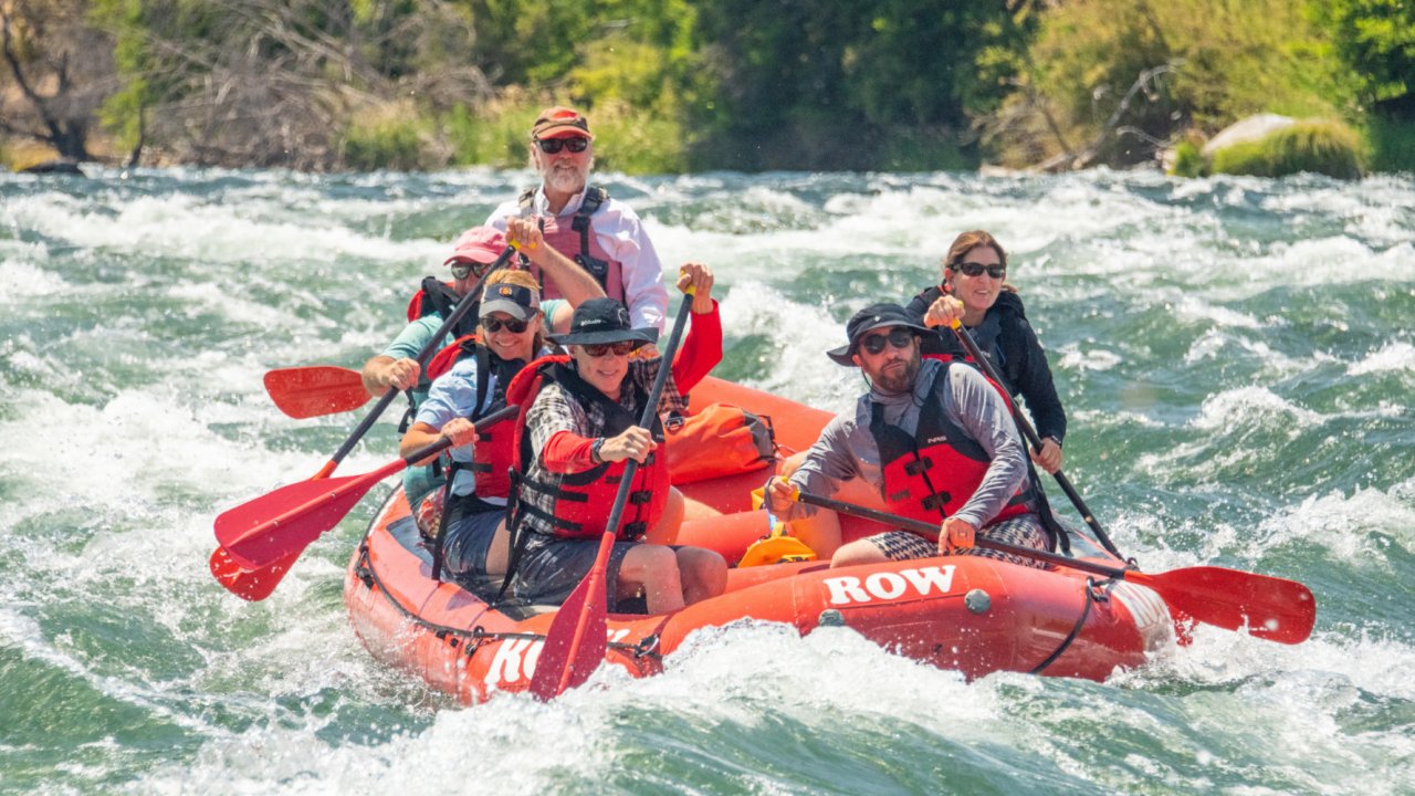 red whitewater raft on rapids