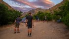 A group of campers playing horseshoe at a sandy campsite along the Snake River