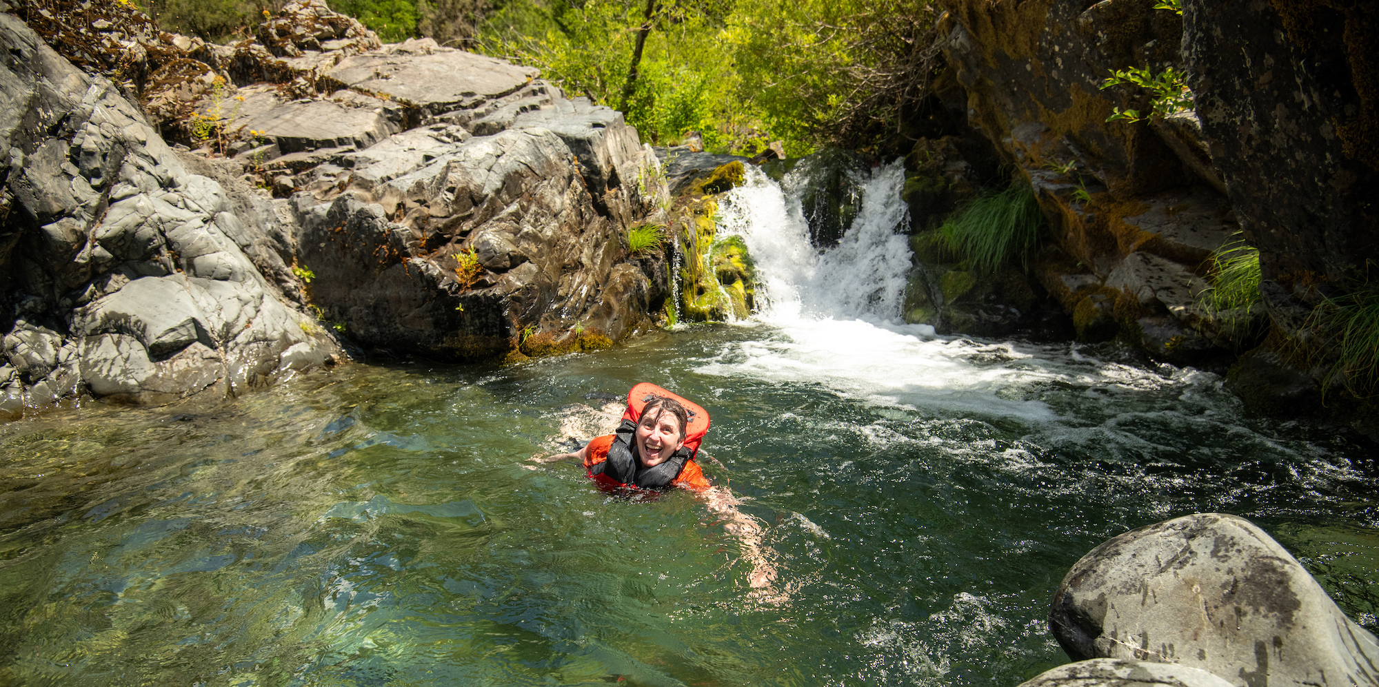 Person with a big smile on their face after cliff jumping along the Rogue River