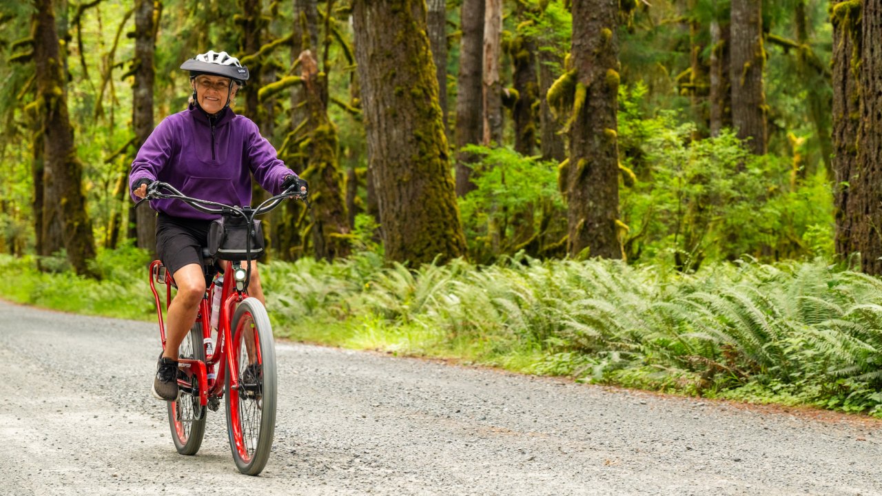 Woman biking along the Olympic Discovery Trail in Washington