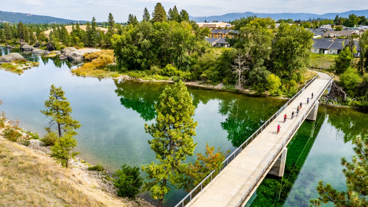 Birds eye view of bikers going over a bridge on the Centennial Trail in Northern Idaho