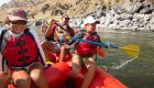 A group of BIPOC children on a red raft on the salmon river
