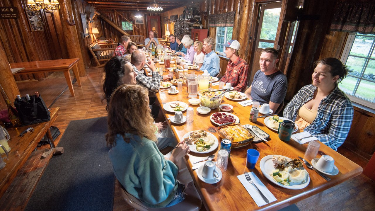 Group of guests around the dinner table at Black Bar Lodge in Oregon
