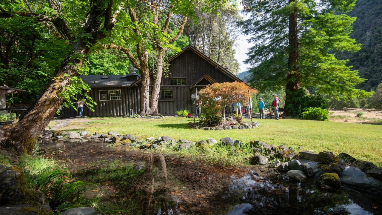People standing outside of the main lodge at Black Bar Lodge in Oregon