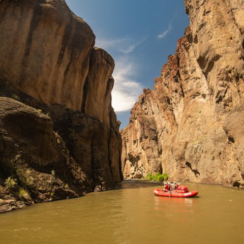 A red ROW raft floating down the Bruneau River in Southwestern Idaho