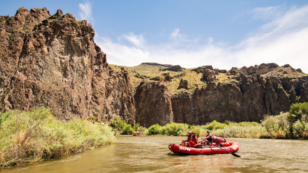 People paddling through a rapid in southern Idaho on a sunny day
