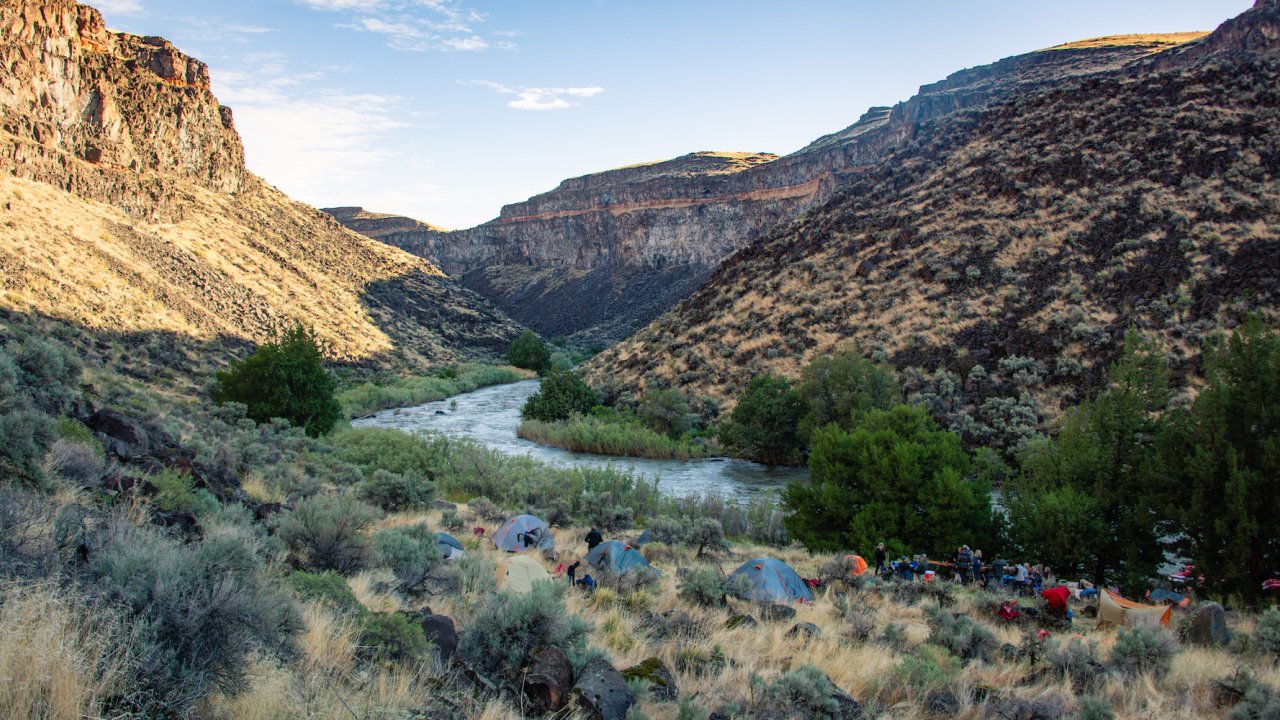 A sprawl of tents spread out riverside in Idaho