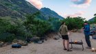Two men standing around the campfire at dusk along the Snake River in Hells Canyon