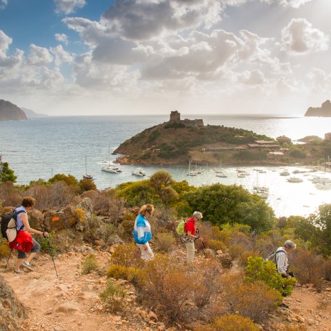 People walking on a trail along the Mediterranean Sea on the island of Corsica