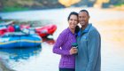 Couple smiling on the beach beside rafts during a Lower Salmon River rafting trip through the scenic Salmon River canyons in Idaho.