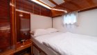 Croatia yacht cabin with one neatly made bed.