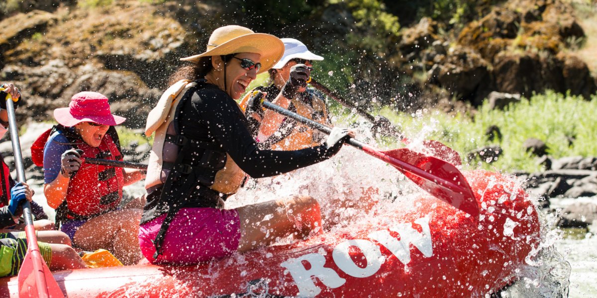 group of white water rafters getting splashed