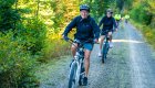A biker in Northern Idaho smiling for the camera on their red bike
