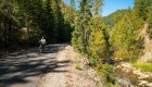 Person on a paved bike trail next to a river 