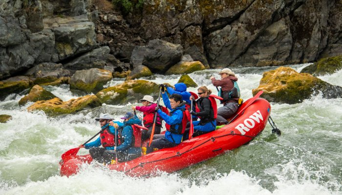 red paddle raft on the snake river going through rapids