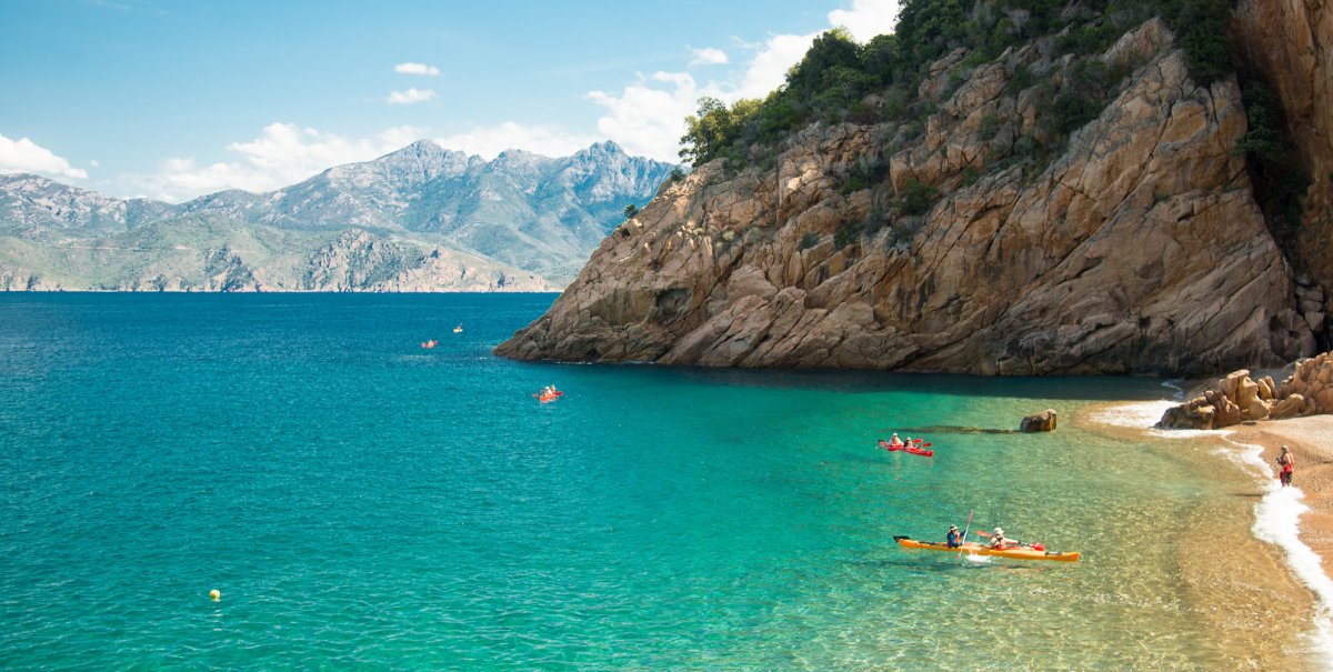 Sea kayakers pulling up to shore in the Mediterranean Sea