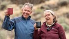 Smiling couple enjoying coffee outdoors on a relaxed family vacation surrounded by nature and desert canyon scenery