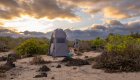 A bathroom tent set up in the middle of a secluded beach