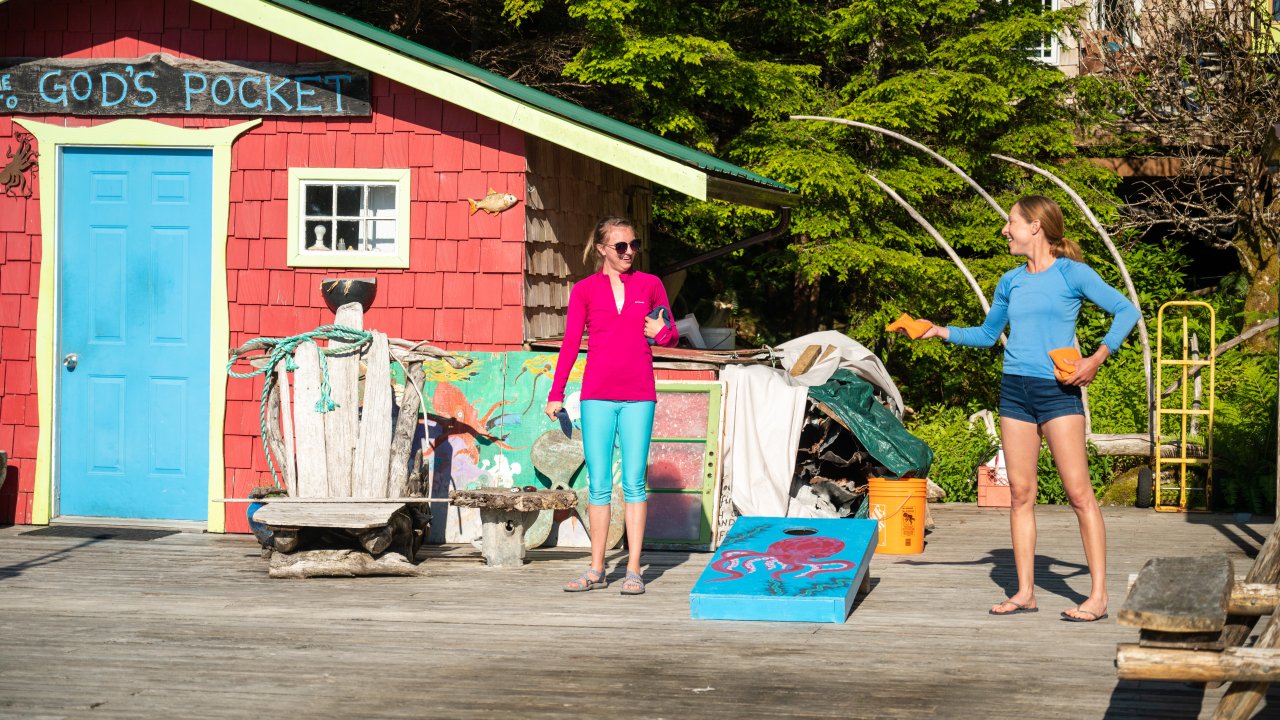 Guests playing corn hole on the sundeck at Gods Pocket