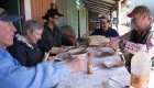 Travelers on a guided hiking tour near Loreto, Mexico, enjoy a traditional meal with locals before exploring the Santa Teresa cave paintings.