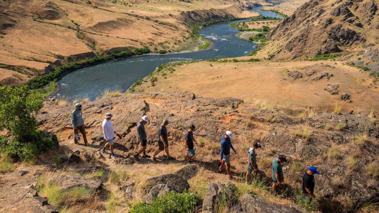 People hiking along Hells Canyon in Idaho during a whitewater rafting trip.