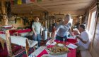 Hikers inside of a rustic lodge in the alps of Albania