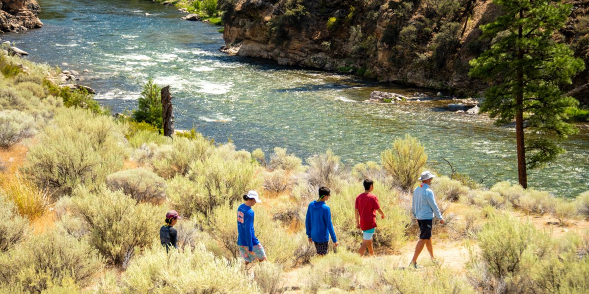 A family enjoys a raft break while hiking a riverside trail along the Middle Fork of the Salmon.