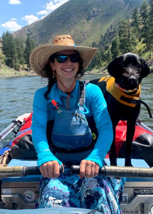 female river guide with dog on raft