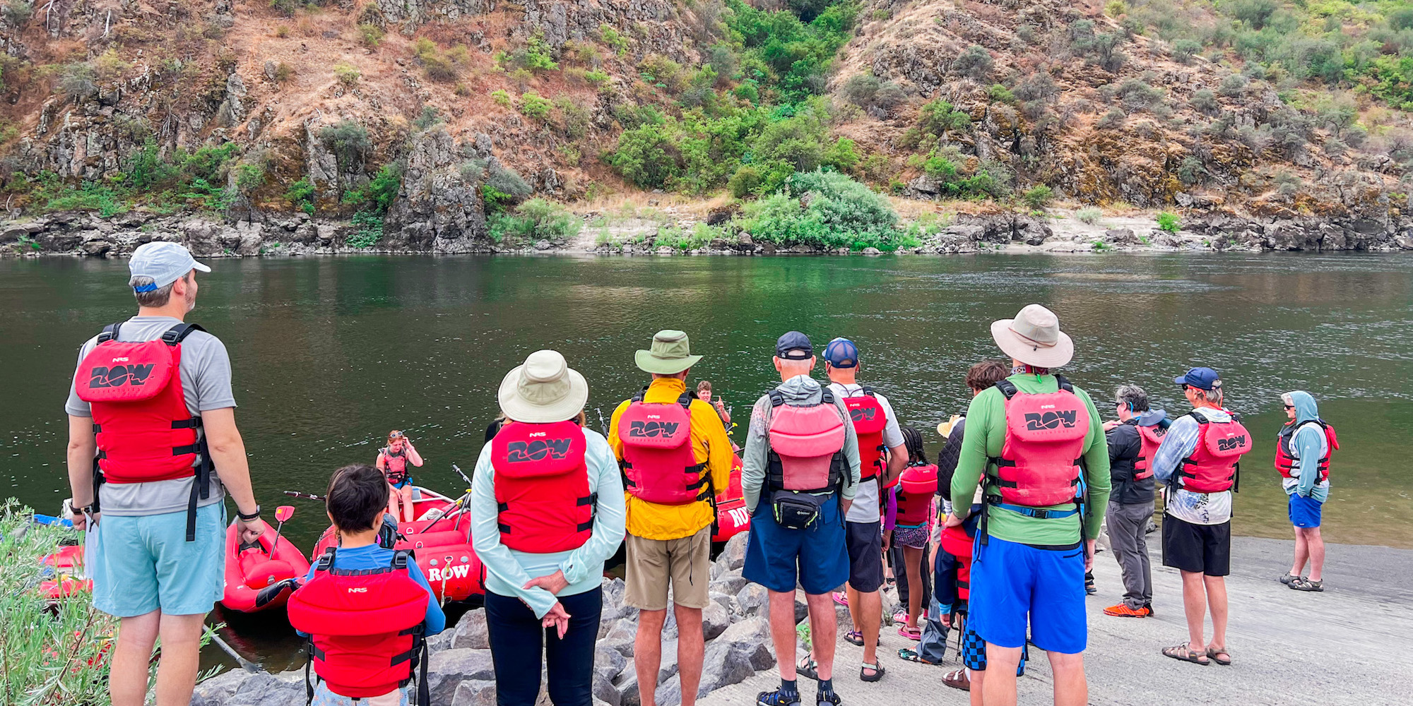 People standing on a boat ramp wearing red PFD's about the launch on the Lower Salmon River