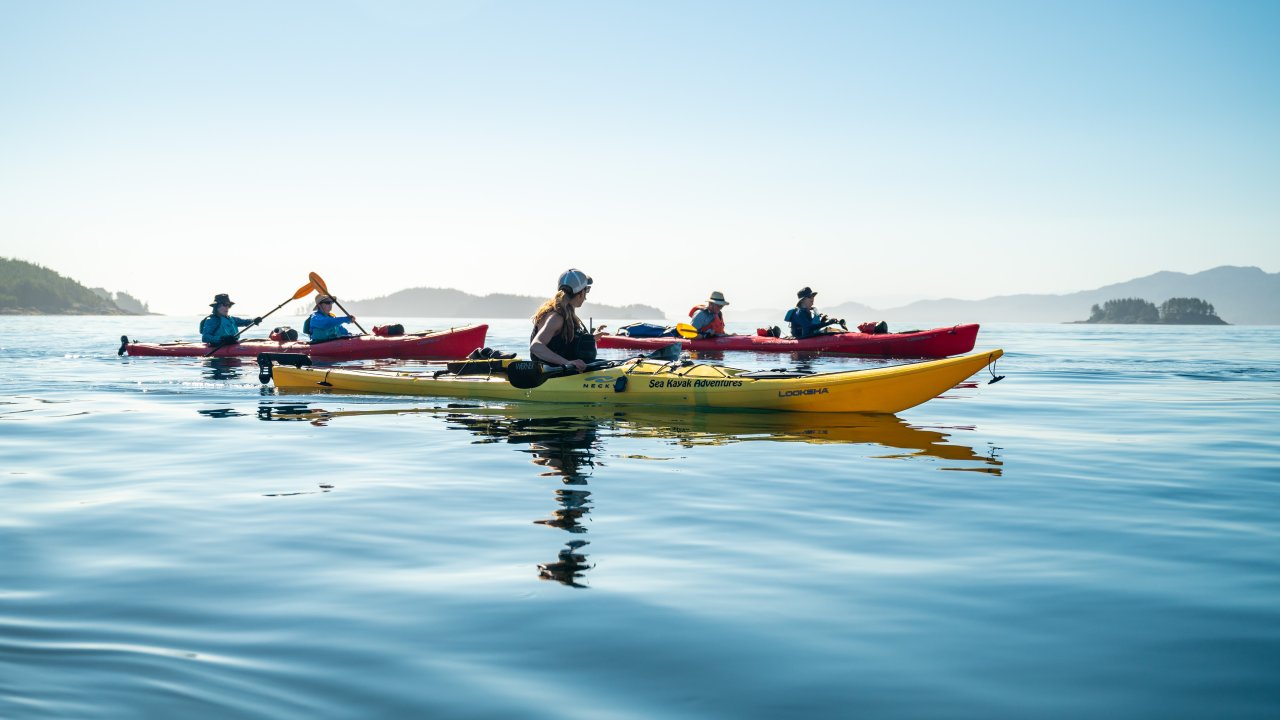 Sea kayakers upon glassy water on the Pacific Ocean