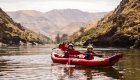 Rafters paddling inflatable kayaks on the Lower Salmon River, surrounded by dramatic Salmon River canyon walls in Idaho.