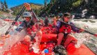 Group enjoying main Salmon River rafting with splashes and whitewater excitement in Idaho.