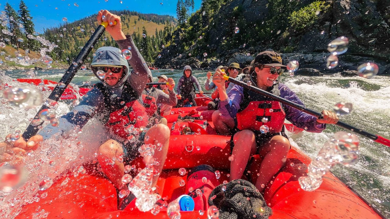 Group enjoying main Salmon River rafting with splashes and whitewater excitement in Idaho.