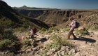 Guided hiking tour near Loreto, Mexico, with travelers trekking rugged canyon trails on the way to see the Santa Teresa cave paintings.