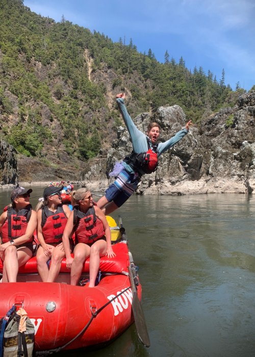 river guide jumping off red raft