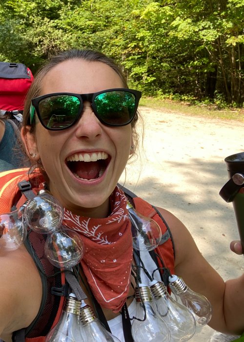 girl with lightbulbs around her neck and big smile