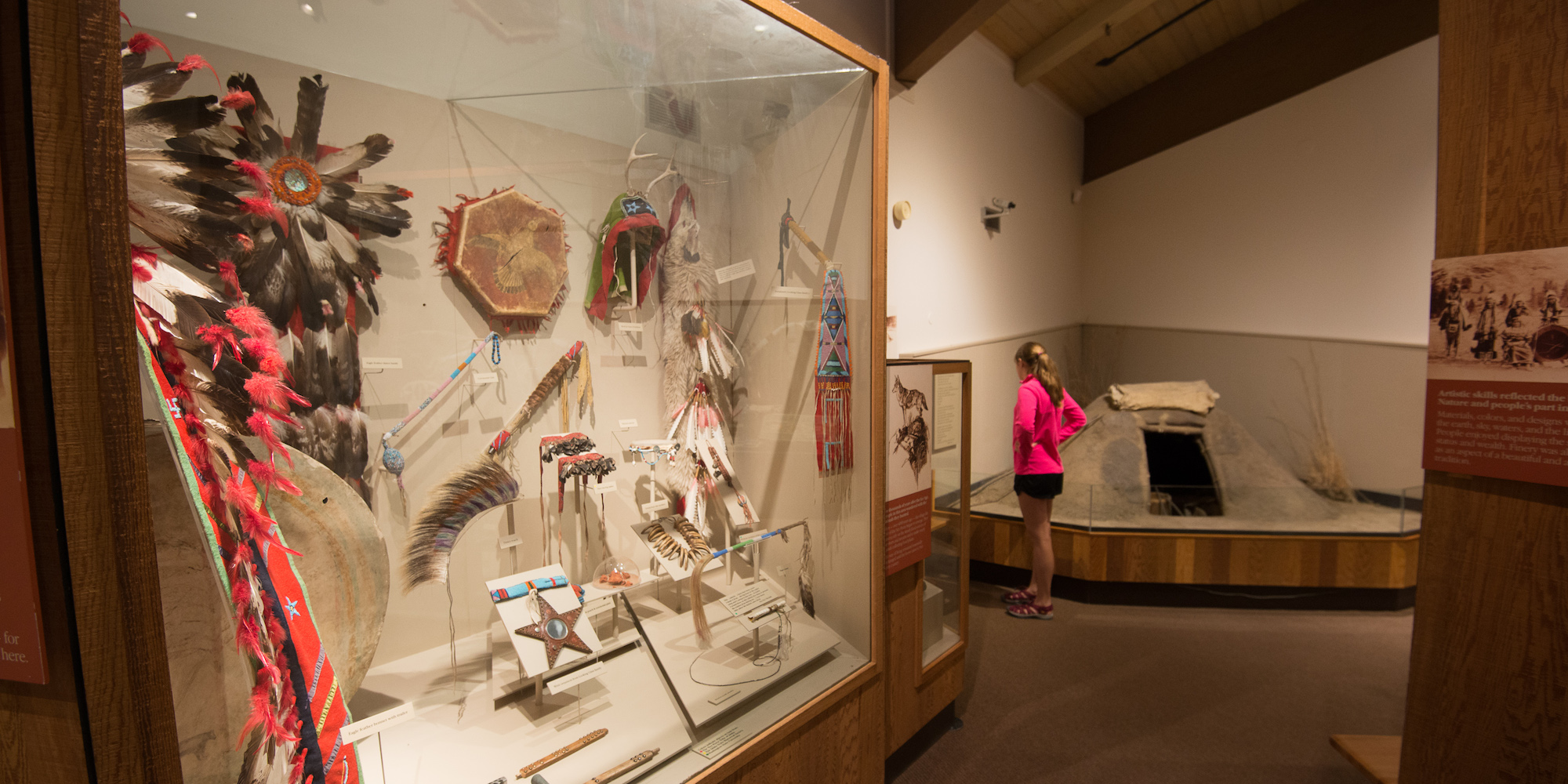 A woman looking into a glass case of historic objects from the Nez Perce Tribe in Lewiston, Idaho