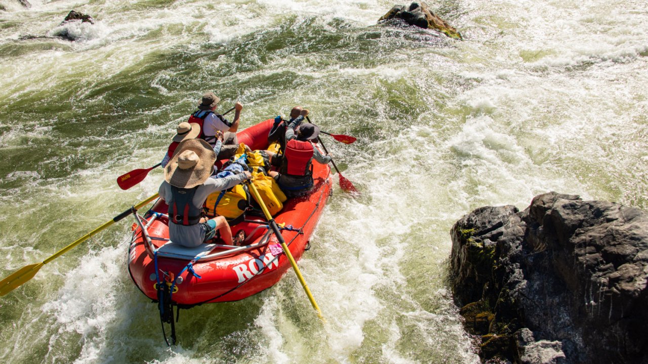 red whitewater raft in rapids