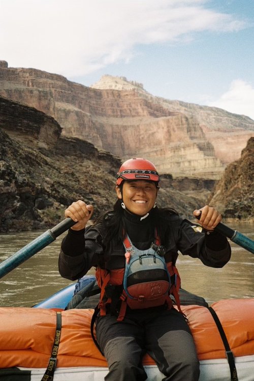ROW Adventures raft guide on a raft going down the river.