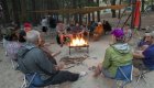 people sitting around campfire