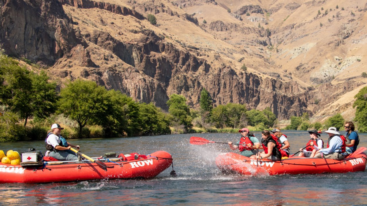 Rafters splashing each other with paddles on the Deschutes River