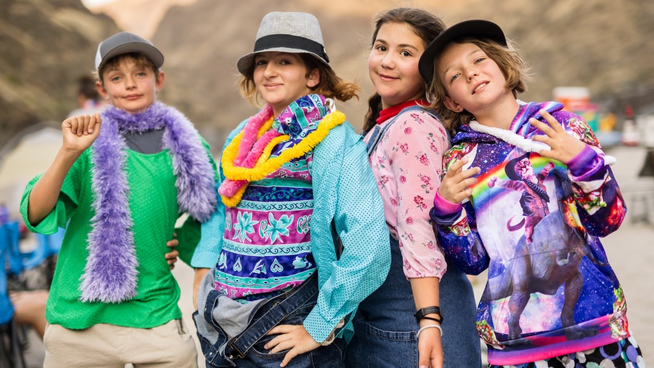 Group of kids dressed up in playful costumes during a rafting trip.