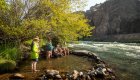 Guests cooling off in a small riverside pool on a hot and sunny day on the Deschutes river