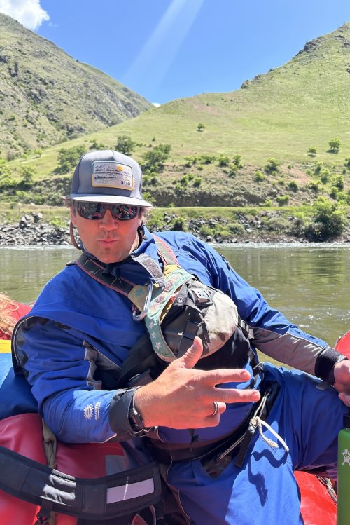 ROW river guide posing on a raft.