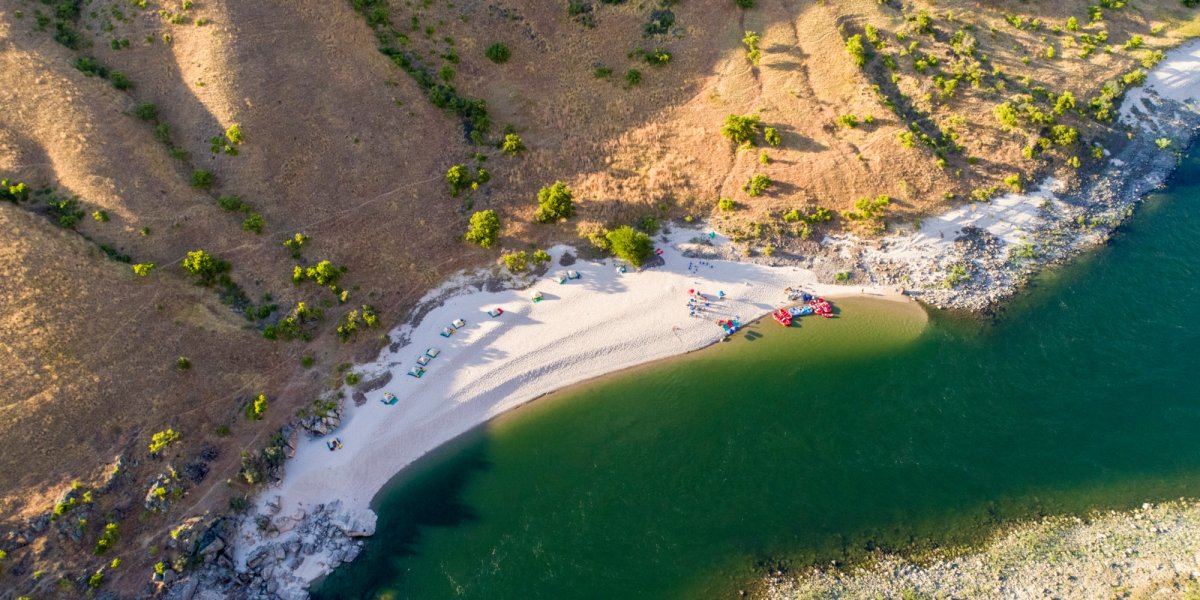 A sandy beach nestled along the shores of the Lower Salmon River Canyons