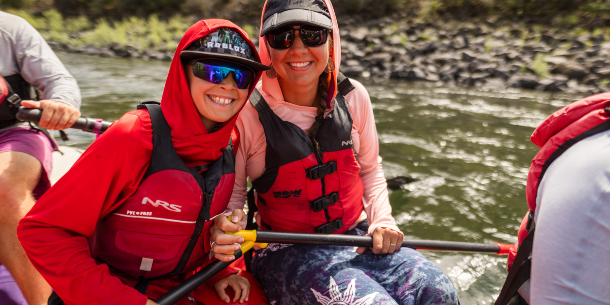 woman and child on a red raft on river