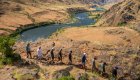 A group of people hiking along the Snake River in Hells Canyon